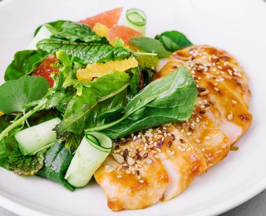 grapefruit and turkey breast salad in white plate