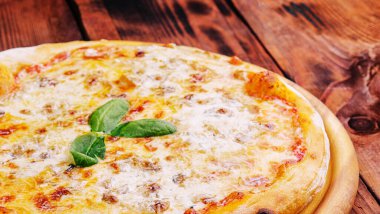 Pizza Margarita on a wooden background