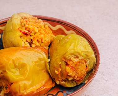 Green peppers stuffed with rice on bowl