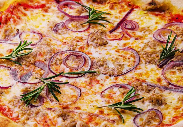 Pizza with tuna and red onion close up