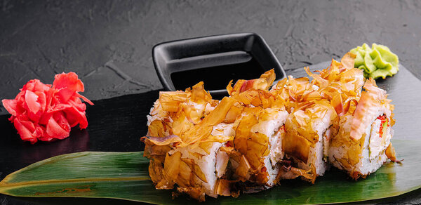 Sushi bonito roll on a dark background
