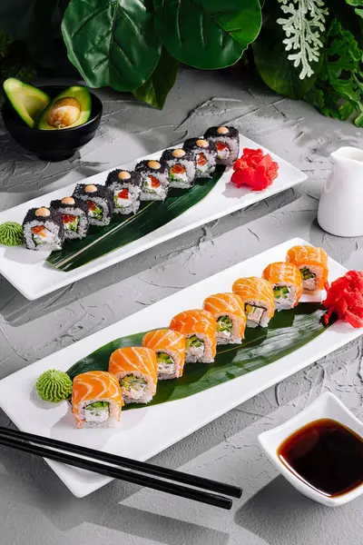 Exquisite and elegant sushi platter presentation showcasing traditional japanese cuisine with gourmet sushi rolls. Fresh raw fish such as salmon and tuna. Delicate nigiri and maki. Seaweed. Wasabi