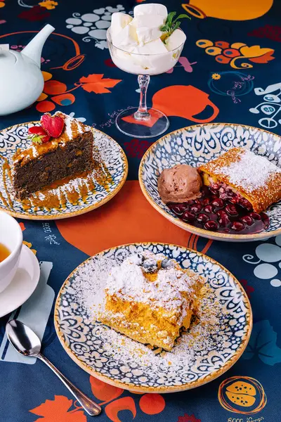stock image Tempting display of various desserts served elegantly on a vibrant table setting