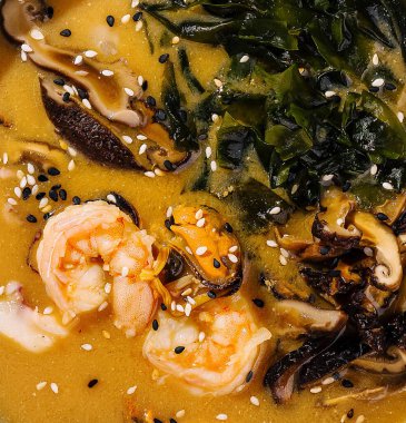 Zengin karides ve sebzeli mantar çorbasının üst görüntüsü.