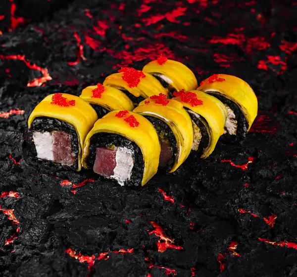 Stock image Artistic sushi presentation with a roll on a dramatic black and red textured background