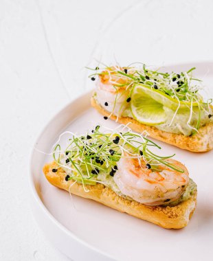 Füme somon, karides ve mikro yeşillikle modern bir tabakta servis edilen iştah açıcı bruschetta.