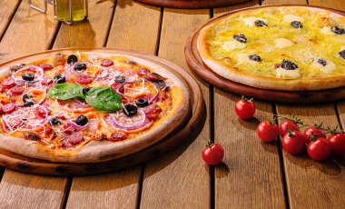 Delicious variety of pizzas on a cozy setup clipart