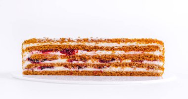 Katmanlı kek, yumuşak sünger, krema ve meyve dolgusunun sıralı bölümlerini içeriyor. Tatlı, zengin dokusu ve tatlı tadı ile davetkar görünüyor. Her durum için mükemmel..