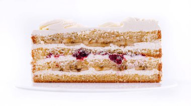 Birkaç parça nemli sünger, krema katmanları ve meyve dolgusu içeren katmanlı bir pasta zarif bir şekilde sergilenmektedir. Bu tatlı her kutlama ve özel durum için idealdir..