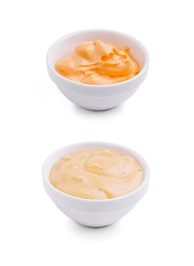 Two bowls of sauces are presented side by side on a white background. The upper bowl contains a bright orange cream, while the lower bowl holds a pale yellow sauce with a smooth texture. clipart