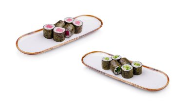 İki tabakta güzel düzenlenmiş suşi ruloları ve taze malzemeler var. Renkli parçalar ustalığı ve Japon mutfağının tipik detaylarına dikkat çekiyor..