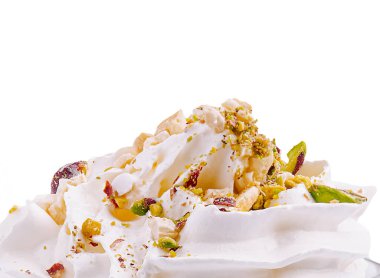 A decadent dessert features a generous layer of whipped cream adorned with chopped nuts and colorful toppings, placed against a clean white background, evoking a sense of indulgence. clipart