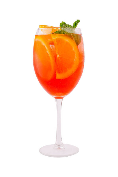 A vibrant cocktail filled with oranges and garnished with fresh mint leaves sits elegantly in a clear glass, perfect for enjoying on a warm summer day.