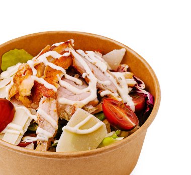 Renkli bir tavuk salatasında çıtır marul, üzümlü domates, ızgara tavuk parçaları ve üstüne serpiştirilmiş krema sosu bulunur..