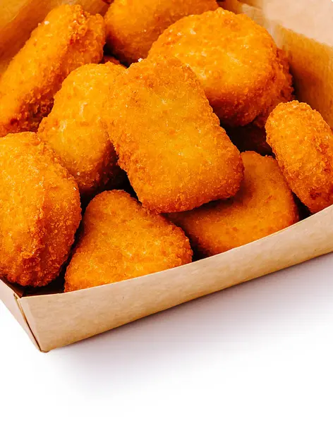 Lezzetli tavuk nugget 'ları karton bir kutuda üst üste yığılır ve çıtır çıtır, altın rengi dış görünüşleriyle sergilenir. Partilerde ya da atıştırmalık olarak yemek yemek için mükemmel..