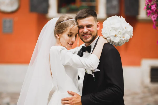 美しい若い結婚式のカップルポージングとともに花束の手 — ストック写真