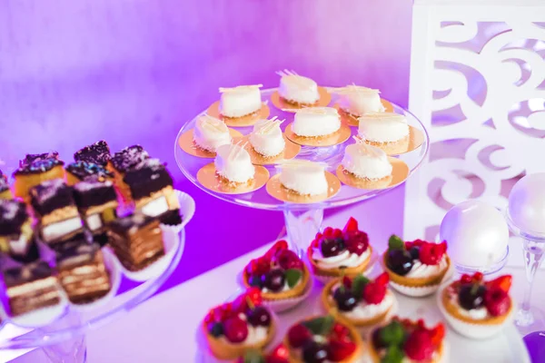 stock image Delicious and tasty dessert table with cupcakes and shots at reception closeup.