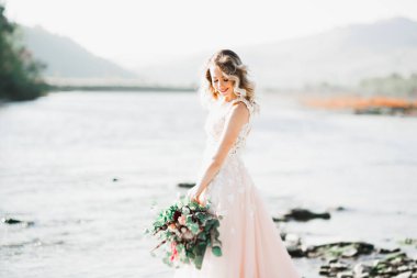 Nehrin kenarında duran uzun saçlı güzel gelinin portresi..