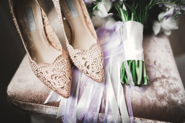 Gül ve diğer çiçekler tha koltuk üzerinde ayakkabı ile bir buket düğün gelinler.