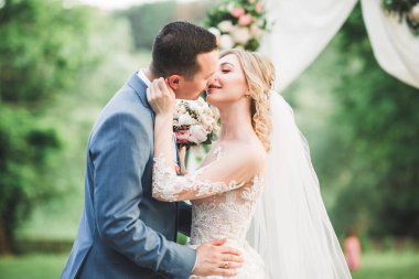 Güzel gelin ve damat evlendikleri gün kucaklaşıp öpüşüyorlar..