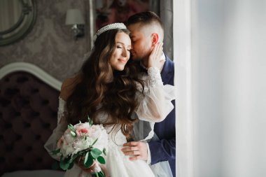 Güzel, genç bir çift ellerinde çiçeklerle poz veriyorlar..