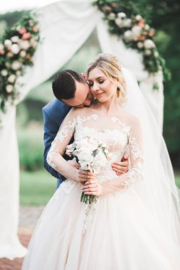 Güzel gelin ve damat evlendikleri gün kucaklaşıp öpüşüyorlar..