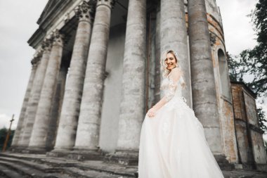 Gelinin güzel portresi moda gelinliği içinde tüylü, lüks makyaj ve saç stili..