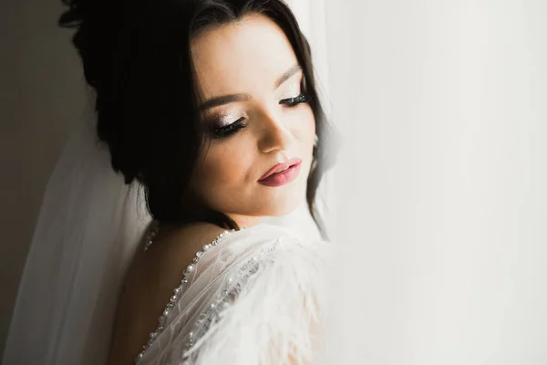Portrait of a beautiful fashion bride, sweet and sensual. Wedding make up and hair.