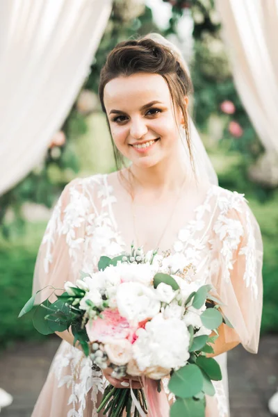 新娘手里拿着花束 又大又漂亮的婚纱 — 图库照片