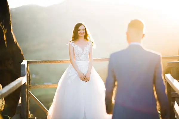 stock image Happy beautiful wedding couple bride and groom at wedding day outdoors on the mountains rock. Happy marriage couple outdoors on nature, soft sunny lights.