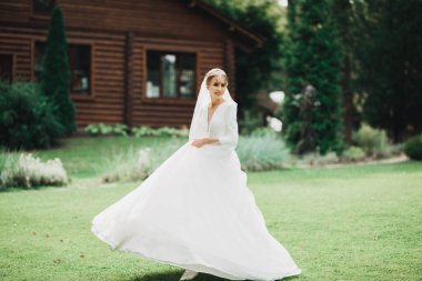 Parkta poz veren gelinlikli güzel, lüks bir gelin..