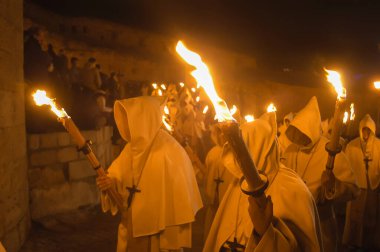 Holy Week procession of Zamora, Spain on the night of Holy Monday of the Penitential Brotherhood of the Holy Christ of Good Death. Penitents with torches procession in the dark night through the old town.