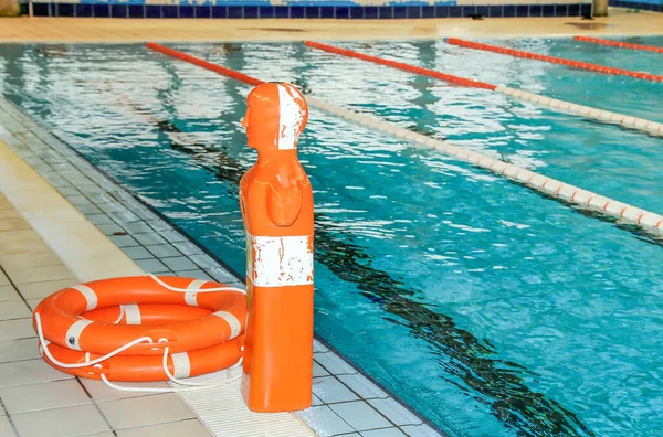 Rescue equipment, dummy and floats in a pool.