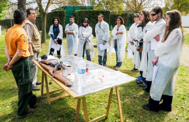 ZAMORA, İspanya - 24 Nisan 2010: Eğitmen bir açık hava hayvan anestezi kursunda bir grup veteriner öğrenciyle konuşuyor.