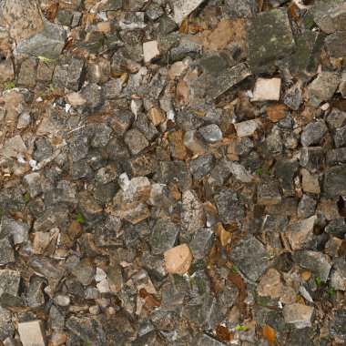 Background texture of old asphalt road with cracks and holes in stone.