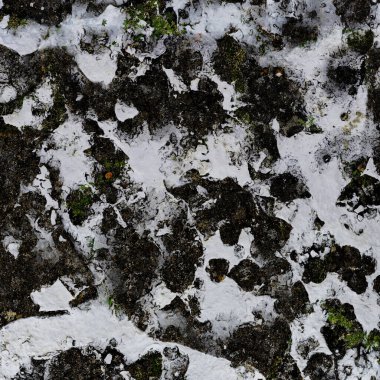 The texture of the stone covered with snow. Close-up.