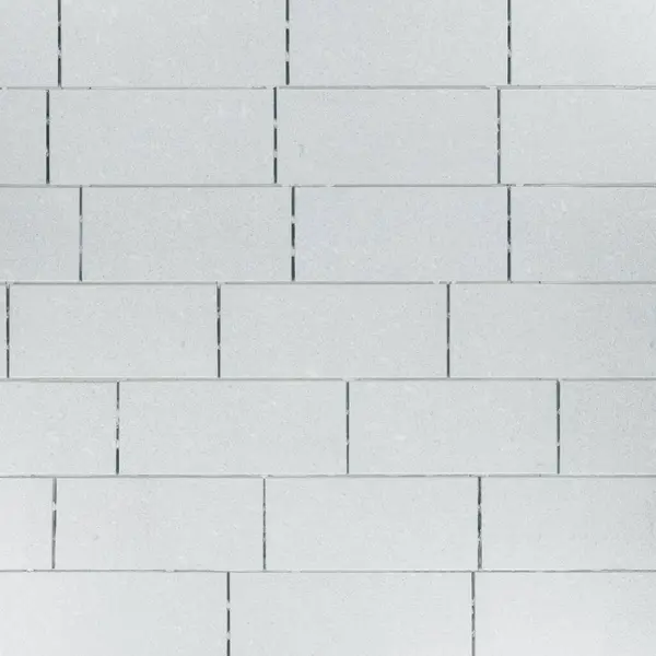 gray brick wall background with white and brown colors