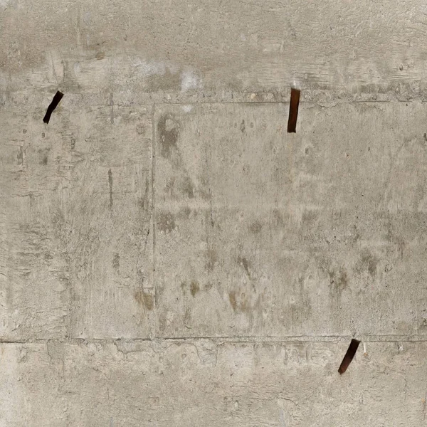 Concrete wall with rusty nails. Background, texture, wallpaper.