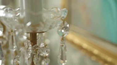 Odanın tavanında büyük bir kristal avize var.