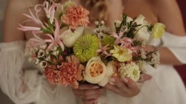Gelin elinde güzel bir buket çiçek tutuyor.