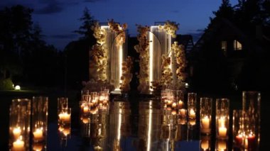 evening arch for a wedding ceremony with candles
