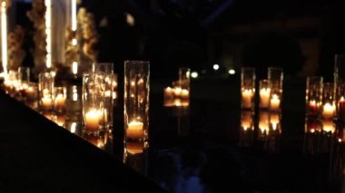 evening wedding ceremony with candles burning near the arch