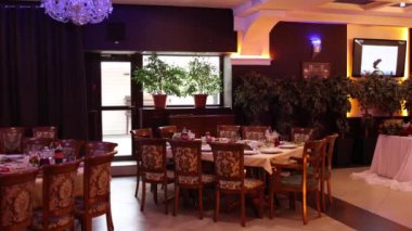 festive tables with food and drinks in a decorated restaurant