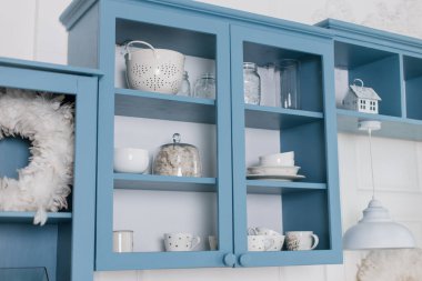 a kitchen shelves with dishes in the kitchen with New Year's decor