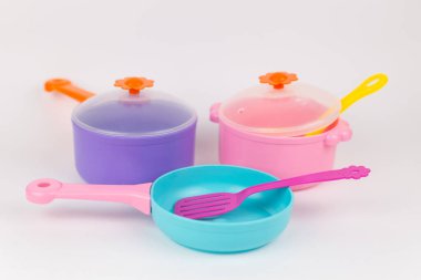 a saucepan frying pan and appliances childish plastic toys on a white background