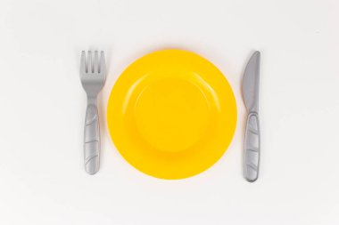 plastic plate with a knife and fork on a white background