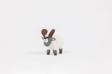 a figure of a ram children's toy on a white background