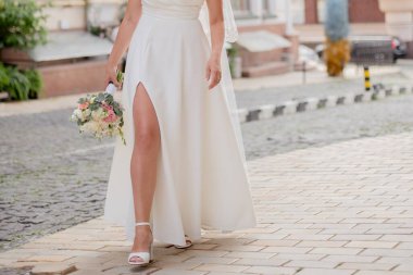 a bride in a wedding dress with a bouquet