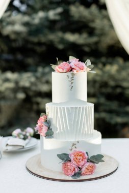 Akşam düğün kemerinin yanında güzel bir düğün pastası.