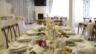 Düğün ya da doğum gününde çiçeklerle süslenmiş bir restoranda bir masa.